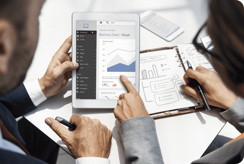 A business owner and a Cappers rep looking at a visual business chart of operational costs on a tablet.